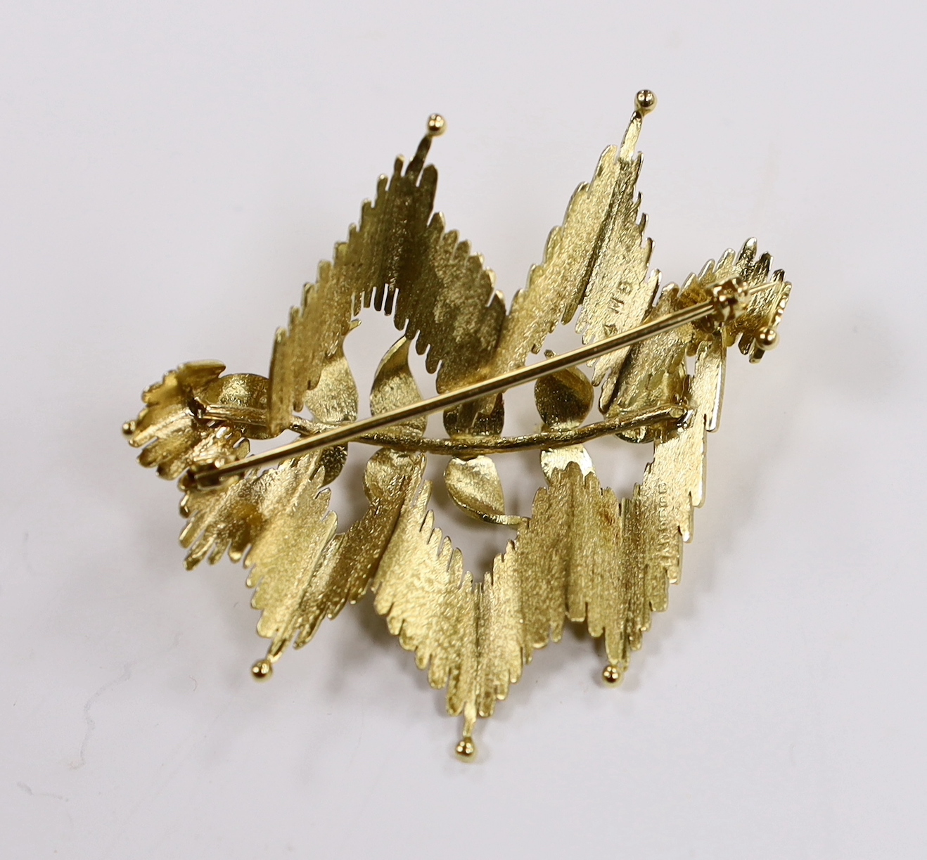 A 1960's 18ct gold, ruby and diamond set stylised foliate brooch, 45mm, gross weight 12.3 grams.